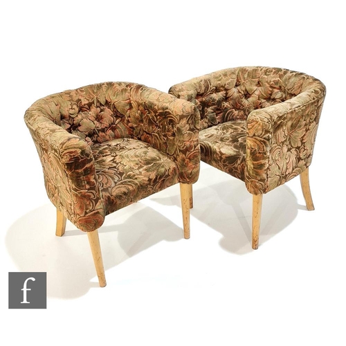 577 - Unknown - A pair of tub shaped club chairs, upholstered in figured foliate pattern fabric above tape... 