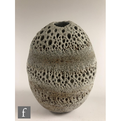 718 - Alan Wallwork - A studio pottery seed form of compressed oval section with incised and stippled deco... 