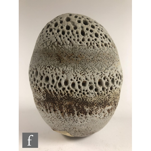 718 - Alan Wallwork - A studio pottery seed form of compressed oval section with incised and stippled deco... 