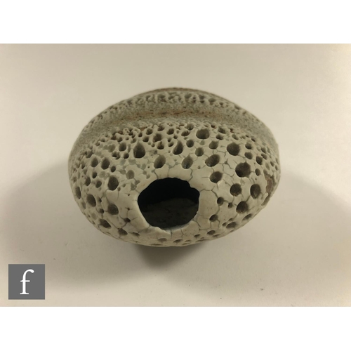 718 - Alan Wallwork - A studio pottery seed form of compressed oval section with incised and stippled deco... 