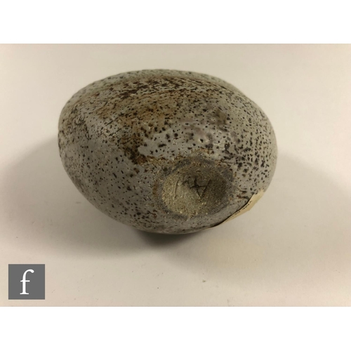 718 - Alan Wallwork - A studio pottery seed form of compressed oval section with incised and stippled deco... 