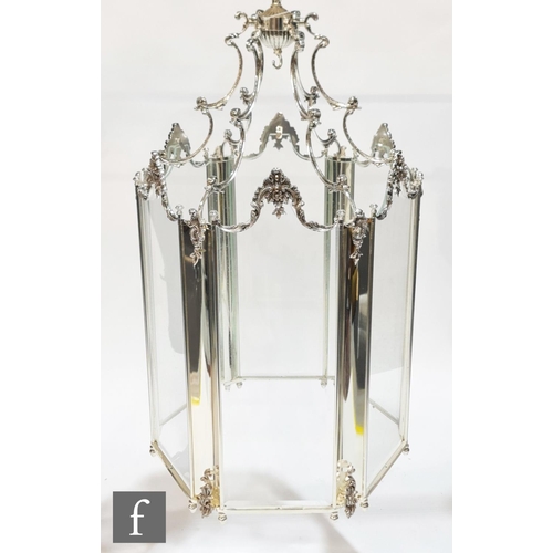 1185 - Unknown - A contemporary silvered glass rococo chandelier, the six glass panels supported in a flora... 