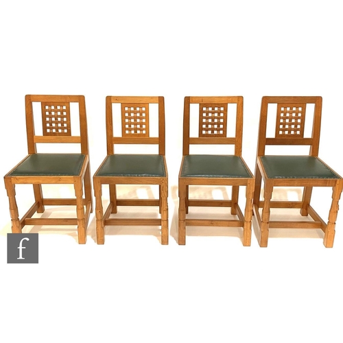 1450 - Robert 'Mouseman' Thompson - A set of four late 20th Century oak lattice back dining chairs, with st... 