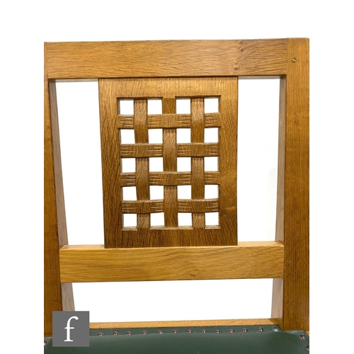 1450 - Robert 'Mouseman' Thompson - A set of four late 20th Century oak lattice back dining chairs, with st... 