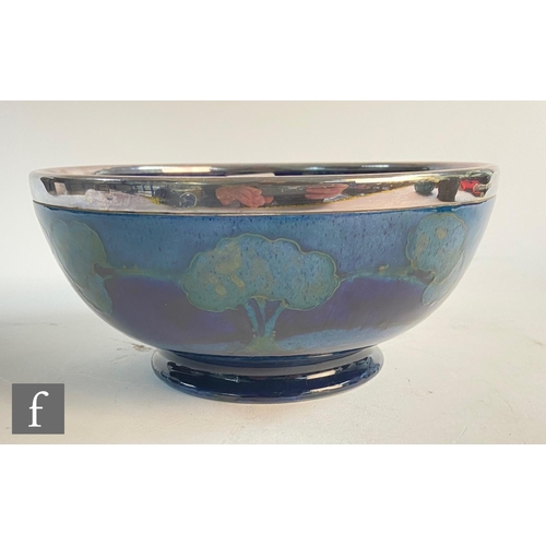 145 - William Moorcroft - A high sided bowl decorated in the Moonlit Blue pattern with trees to the interi... 