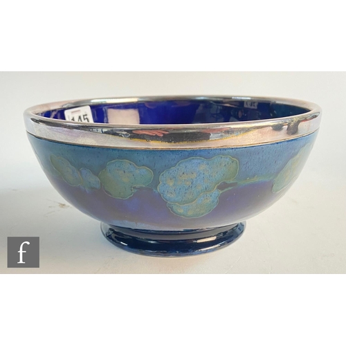 145 - William Moorcroft - A high sided bowl decorated in the Moonlit Blue pattern with trees to the interi... 