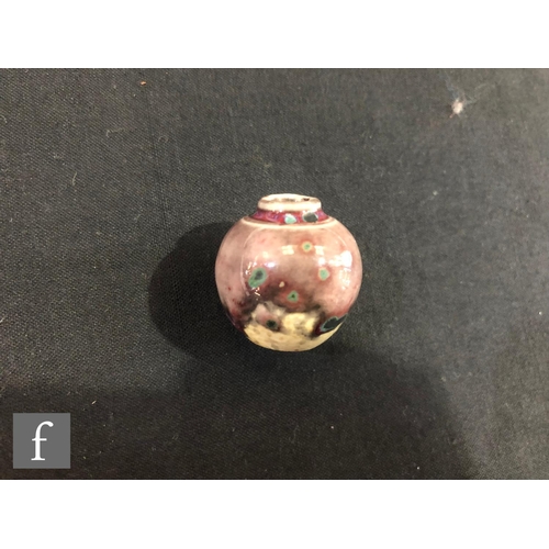 130 - Ruskin Pottery - A high fired miniature vase of globular form decorated in a sweeping tonal purple g... 