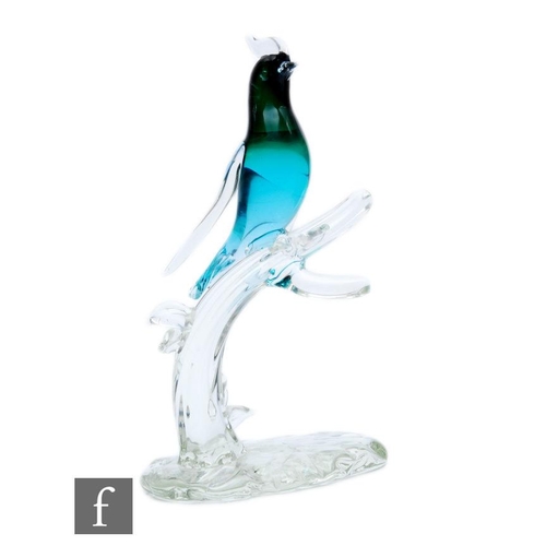 193 - A later 20th Century Italian Murano glass figure of a stylised bird in tonal turquoise resting to a ... 