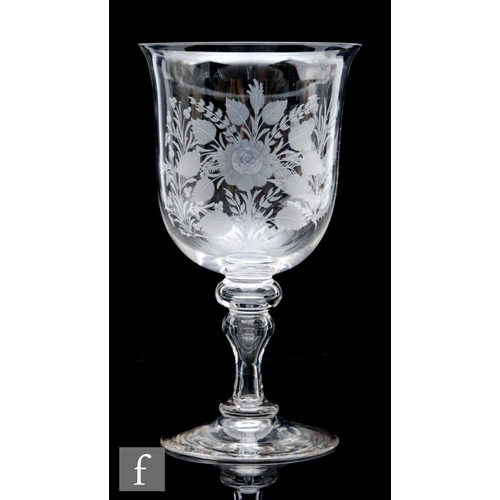 388 - A large late 19th to early 20th Century clear crystal glass goblet, the bell form bowl engraved with... 