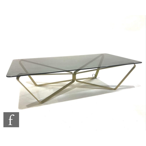 1322 - A contemporary Minotti glass table, the smoked glass rectangular top raised on an abstract brushed g... 