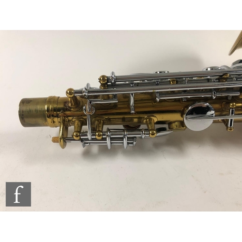 635 - A British made brass saxophone by Lafleur London, with mouth piece, in plush lined case, width 59cm.