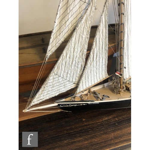 558 - A 1940s or later model pond yacht on wooden stand with beam, length 74cm, a similar single masted ya... 