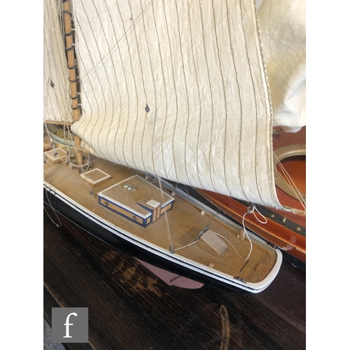 558 - A 1940s or later model pond yacht on wooden stand with beam, length 74cm, a similar single masted ya... 