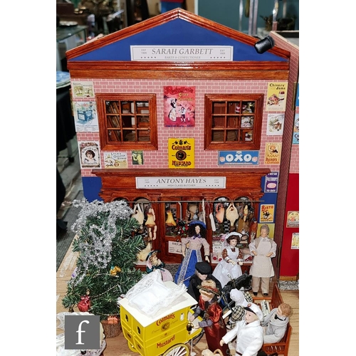 1186 - A two storey hinged front dolls house modelled as a shop, the ground floor as Antony Hayes Butcher, ... 