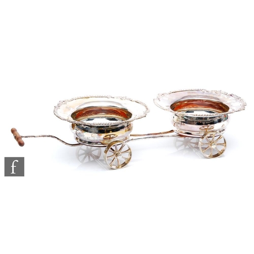 101 - A double bottle coaster table cart, twin hallmarked silver bottle coasters each with gadroon and fol... 