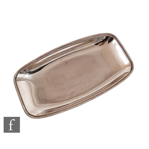 103 - A hallmarked silver cushioned rectangular side dish of plain form, weight 18.5oz, length 31cm, termi... 