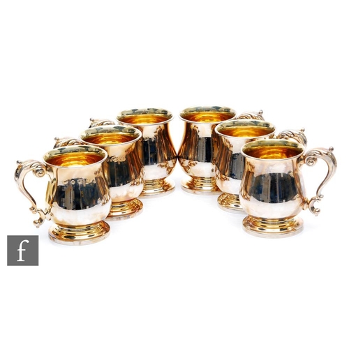 104 - A set of six hallmarked silver half pint tankards of plain baluster form, total weight 31oz, heights... 