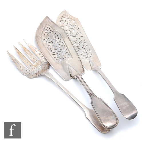 112 - A Victorian hallmarked silver fiddle pattern fish slice and fork each with pierced blades, with a  f... 