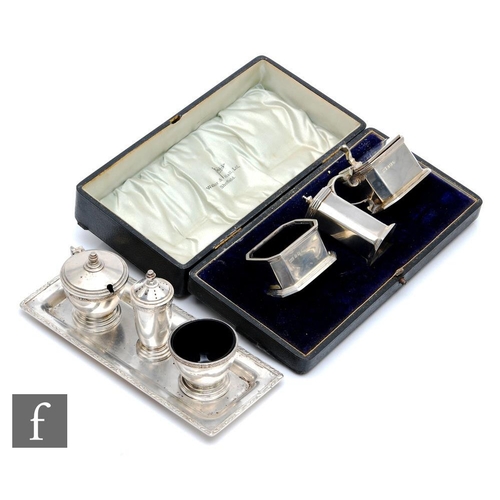 116 - A cased hallmarked silver Art Deco three piece cruet set of canted rectangular form, with a similar ... 