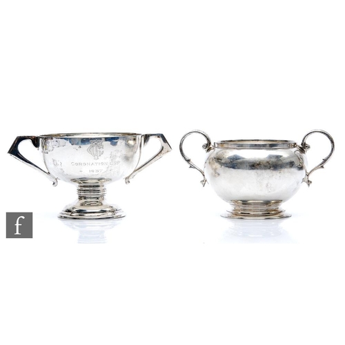 122 - A hallmarked silver twin handed sugar basin with a similar small trophy cup, total weight 10.5oz, va... 