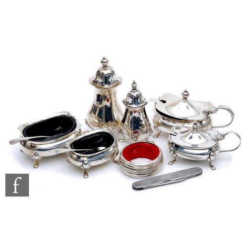 123 - Two hallmarked silver boat shaped three piece cruet sets with a silver penknife and a drip collar, t... 