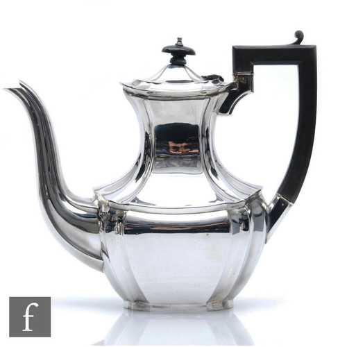 130 - A hallmarked silver Queen Anne style coffee pot of plain form with scroll wooden handle, weight 25oz... 