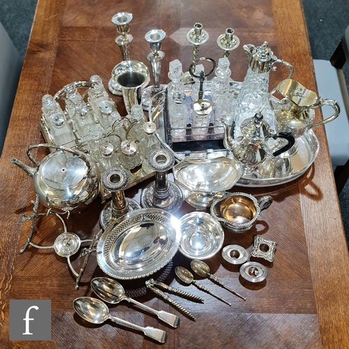 134 - A parcel lot of assorted silver plated items to include a gallery tray, claret jug, cruet stand and ... 