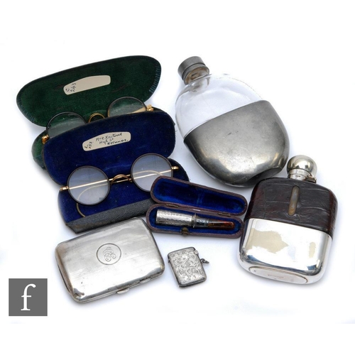 135 - A hallmarked silver cigarette case with two silver plated hip flasks, a silver vesta case, two pairs... 