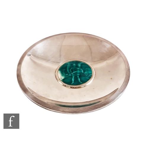 137 - A Scandinavian silver circular shallow dish with central green enamel scene of a Viking stood in fro... 