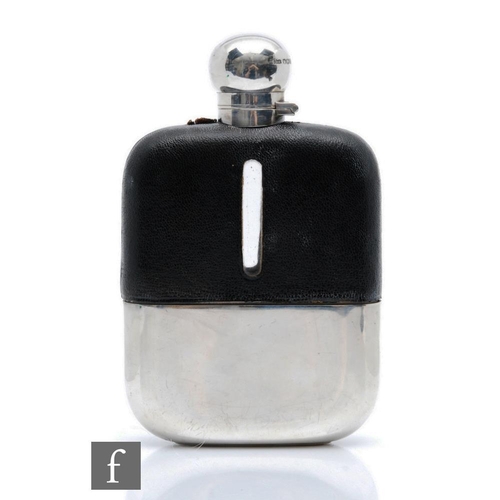 14 - A hallmarked silver, clear glass and leather hip flask of typical form, terminating in cork lined ba... 