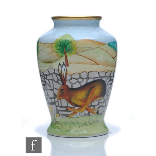 144 - A boxed Moorcroft Enamels 'Yorkshire Hare' vase designed by Sian Leeper with a hare running beside a... 