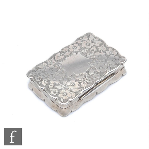 166 - A hallmarked silver rectangular snuff box with foliate engraved decoration to whole within shaped bo... 