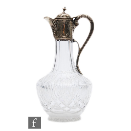 17 - A Victorian hallmarked silver and clear claret jug, cut glass body below silver collar, hinged cover... 