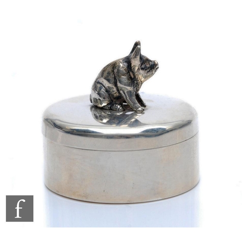 171 - A hallmarked silver circular box and cover detailed with a seated pig to cover, weight 46.5g, diamet... 