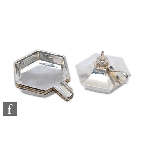 175 - A hallmarked silver hexagonal shaped table lighter with scroll handle and four conforming ashtrays, ... 