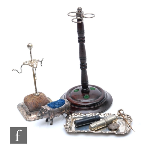 203 - A silver plated hat pin stand with another turned wooden example, a Sterling silver pin tray, a silv... 