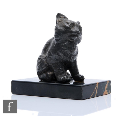 206 - A bronze study of a seated cat to a variegated black marble base, length 12cm.