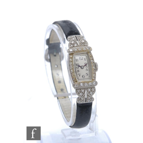 241 - A lady's early 20th Century platinum diamond set wristwatch, Arabic numerals to a cushioned rectangu... 