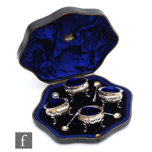 28 - A cased set of four hallmarked silver circular open salts, each raised on four pad feet and terminat... 