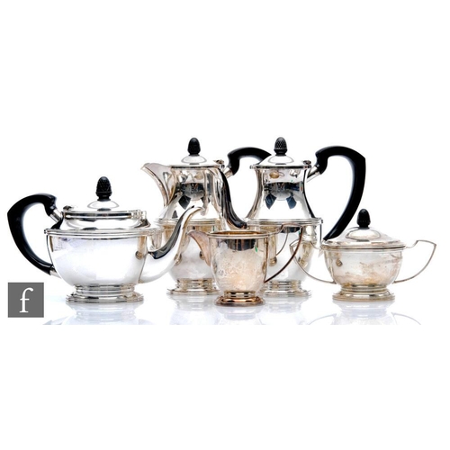 36 - A hallmarked silver five piece pedestal tea set of plain form with reeded details, the three pots an... 