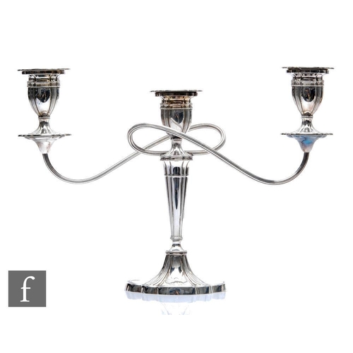 38 - A hallmarked silver three light candelabra, shaped oval base below fluted column, twin reeded arms a... 