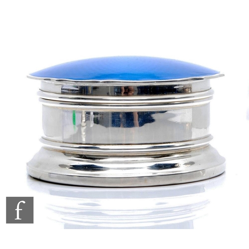 44 - A hallmarked silver and enamel decorated trinket box of shaped circular stepped form, the guilloche ... 