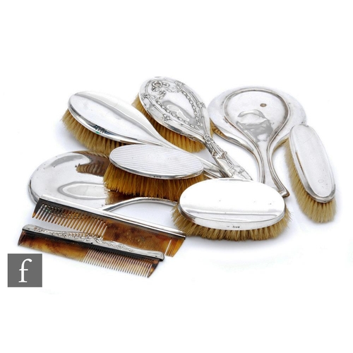 51 - A parcel lot of hallmarked silver backed hair brushes, combs and hand mirrors, various styles and da... 