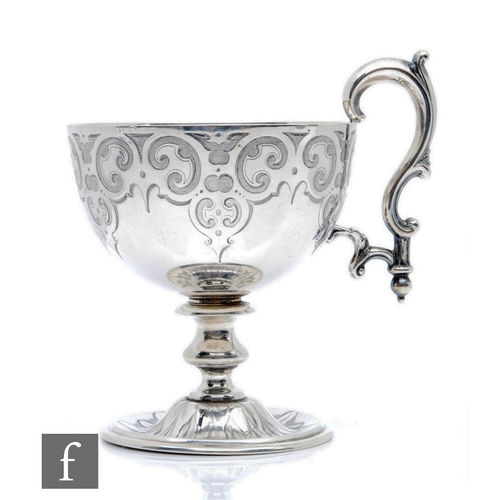 57 - A Victorian hallmarked silver pedestal cup, circular foot below knopped stem and part foliate engrav... 