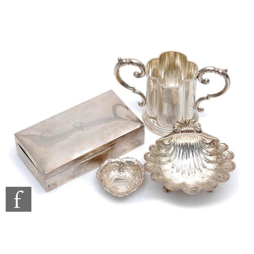 62 - Four items of hallmarked silver, a cigarette box, a pedestal bon bon dish, a twin handled cup and a ... 