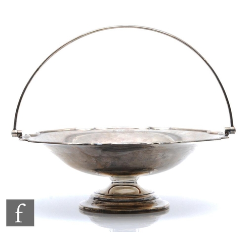 9 - A hallmarked silver pedestal swing basket, circular stepped base below plain bowl and arched swing h... 