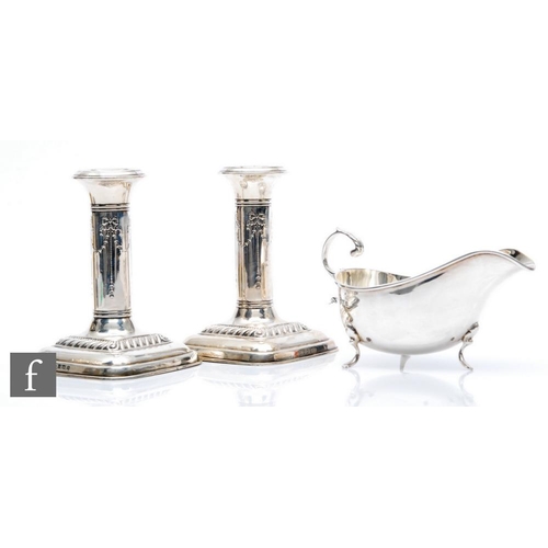 95 - A pair of hallmarked silver piano candlesticks with ribbon and swag decoration to columns, height 12... 