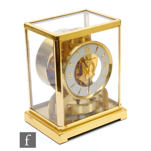 214 - A Jaeger-Lecoultre Atmos clock, circular white dial in brass glazed case, on plinth base, height 22.... 