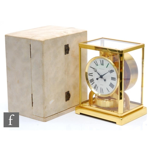 215 - A Jaeger-Lecoultre Atmos clock, circular white dial in brass glazed case on bracket plinth base, in ... 