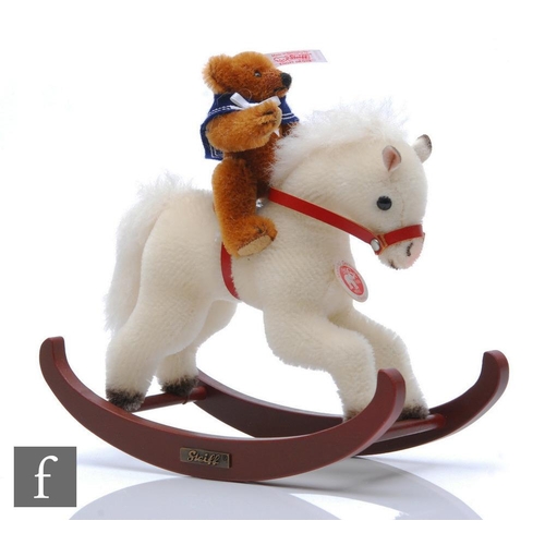 1168 - A Steiff 037337 Teddy Bear with Rocking Horse, reddish brown mohair, height 8cm, on white mohair roc... 